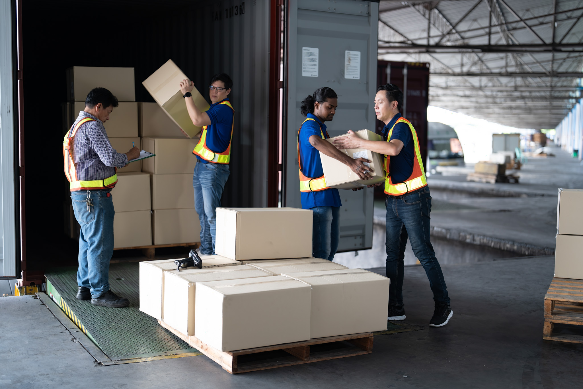 CPM crew diligently packing and loading boxes for international shipping, emphasizing global moving expertise.