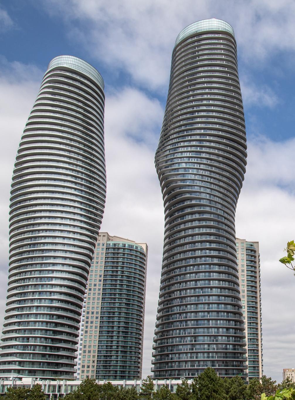 Twisting towers of Mississauga under a cloudy sky, showcasing CPM's robust moving services in urban landscapes.