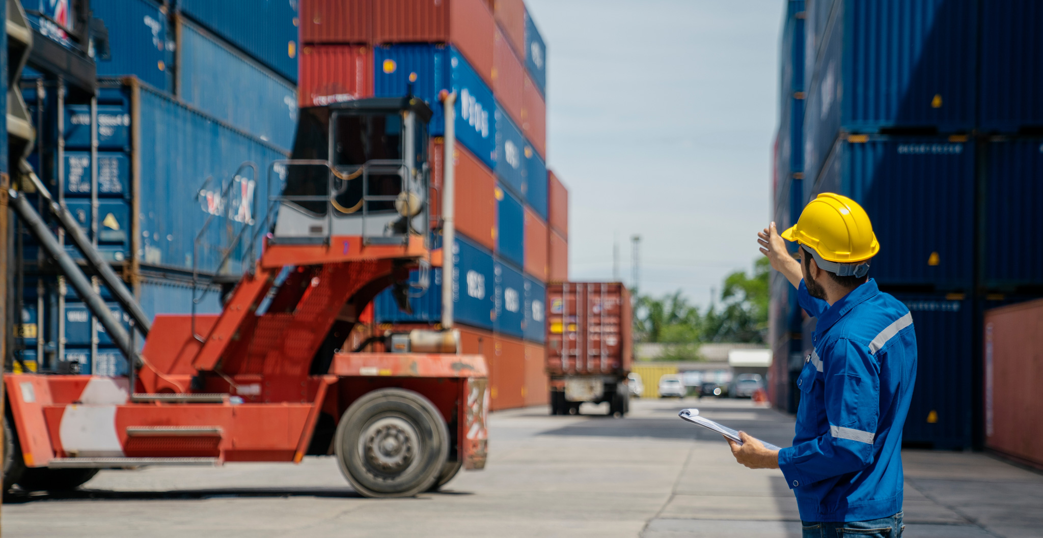 Logistics expert from CPM overseeing the organized loading of cargo containers, ensuring efficient and secure transport.