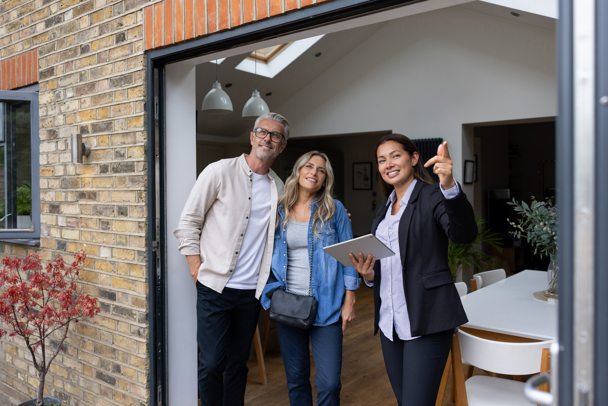 A Canadian Preferred Moving agent enthusiastically guiding a couple through their potential new home.