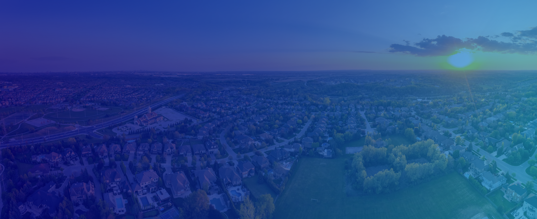 Suburban neighborhood at sunset, showcasing potential homes for Canadian Preferred Moving services.