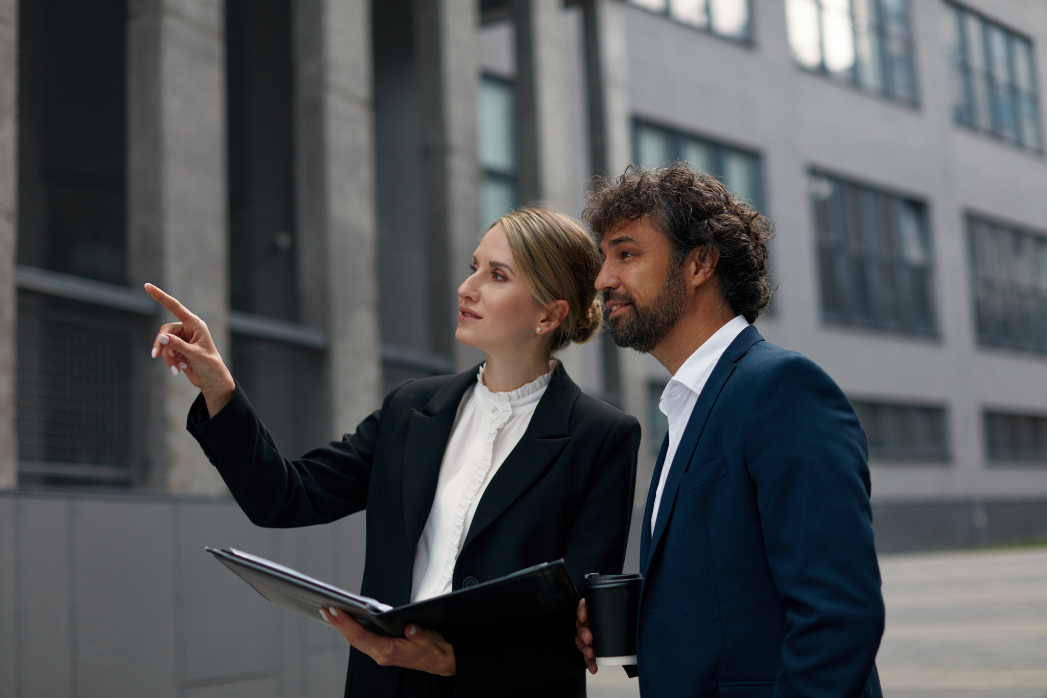 wo Canadian Preferred Moving consultants discussing project details outside a business facility.