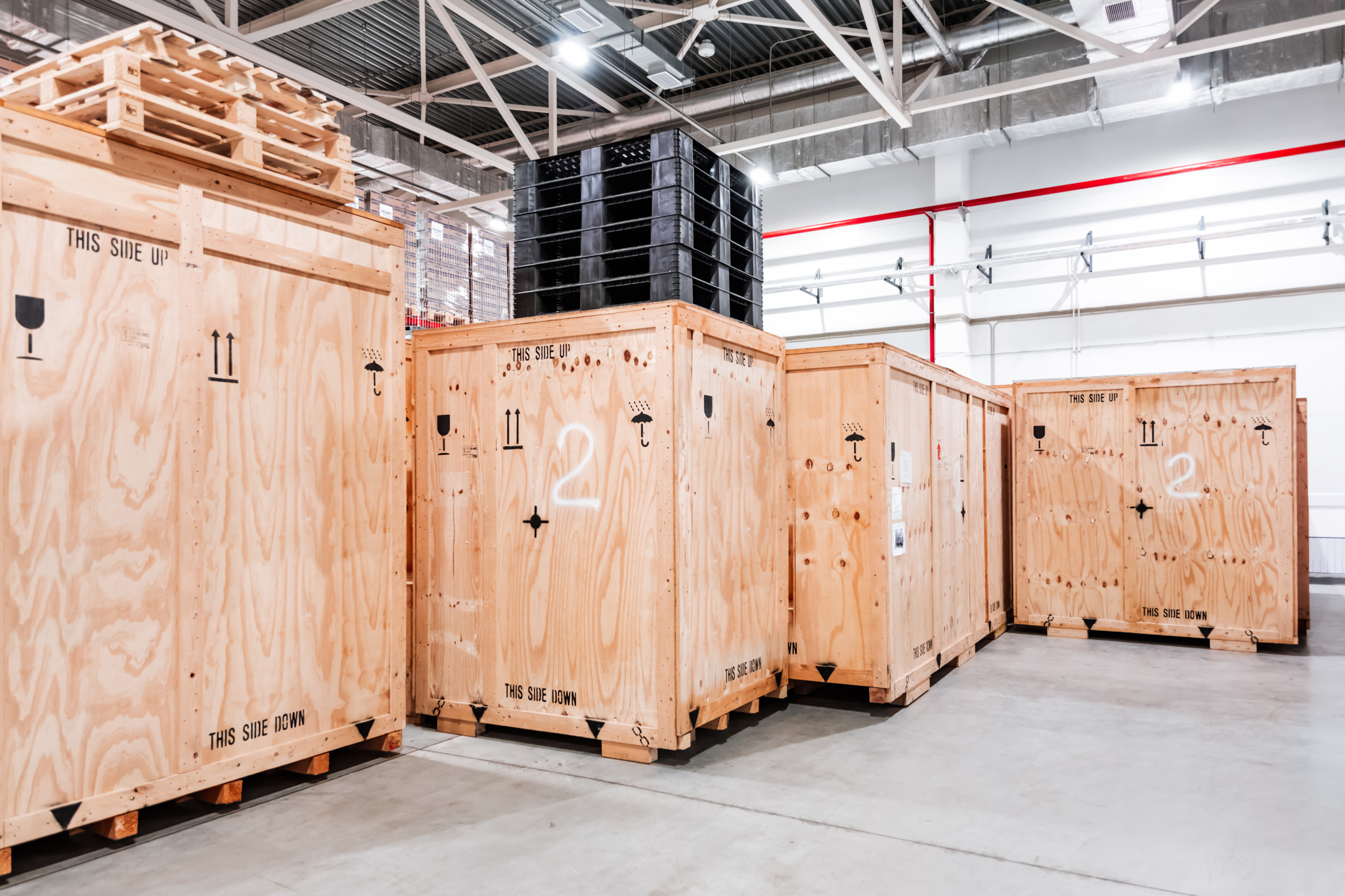 Wooden storage crates labeled for secure handling in Canadian Preferred Moving's storage facility.