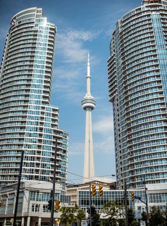 CN Tower framed by modern buildings, a symbol of the vibrant region served by Canadian Preferred Moving in Whitby, Ontario.
