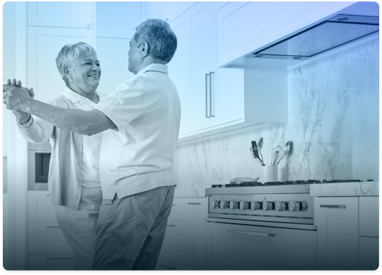 Happy senior couple dancing in their new kitchen, a testament to a stress-free move with Canadian Preferred Moving.