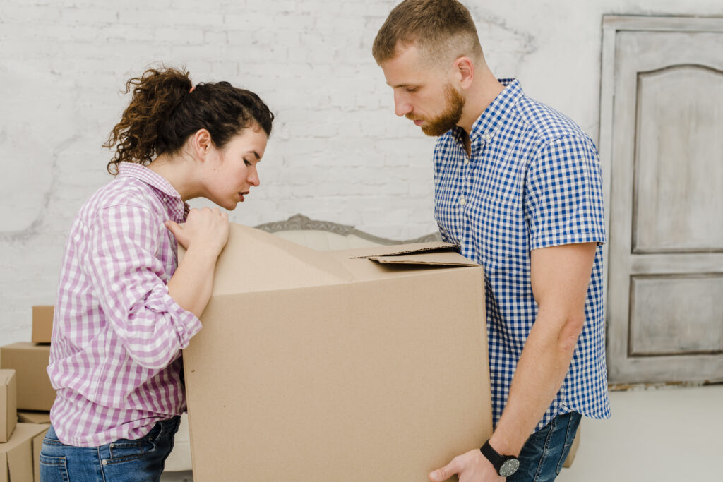 Couple unpacking their moving boxes after moving to Moncton NB