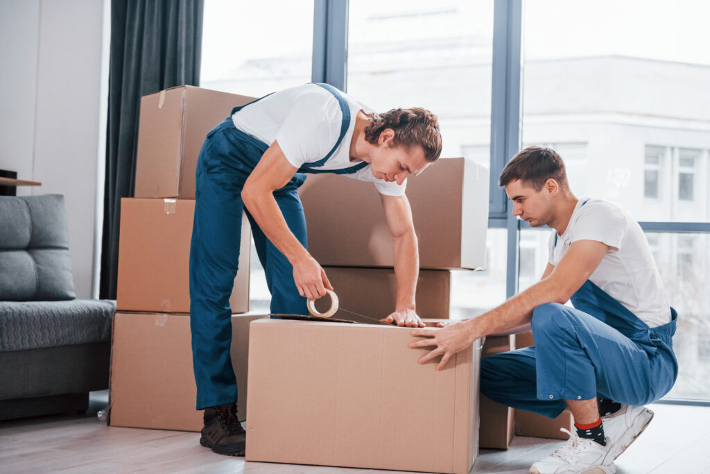 CPM Moving professional carefully packing a moving box