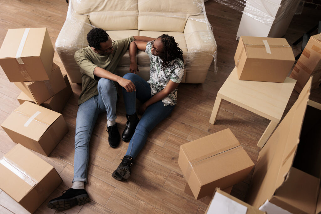 Happy family unpacking in their new house with moving boxes around