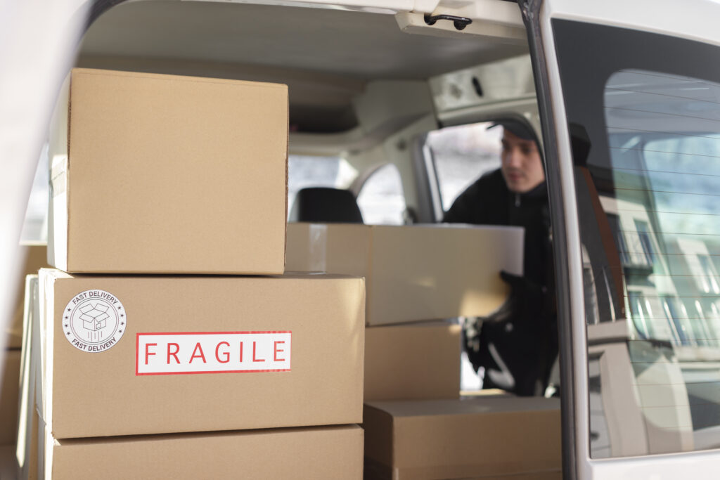 Boxes labeled “Fragile” stacked in a moving storage facility