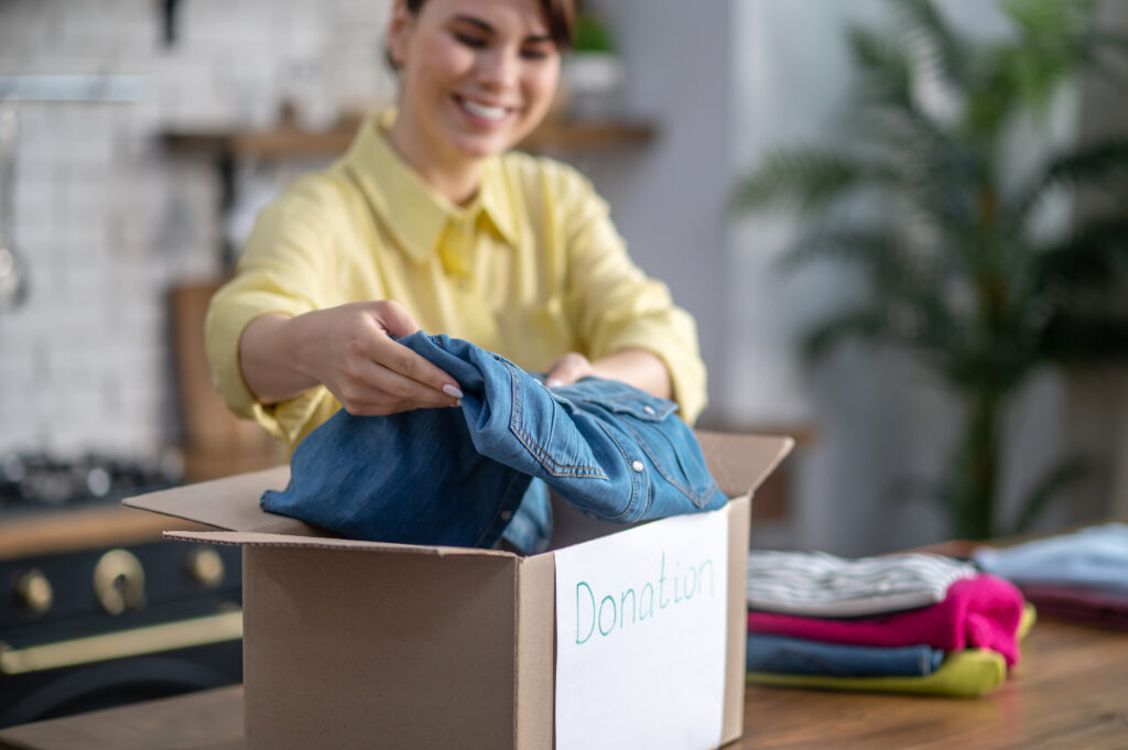 Boxes labeled for donation and recycling in preparation for a sustainable move
