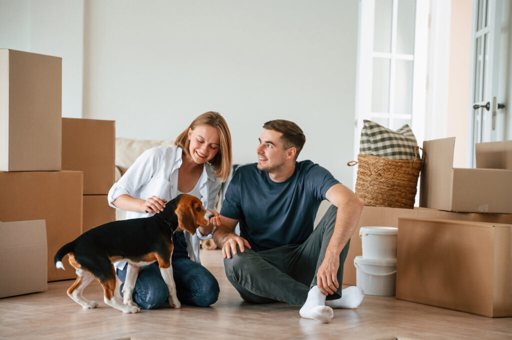 Family packing moving boxes in Canada before a US-bound move