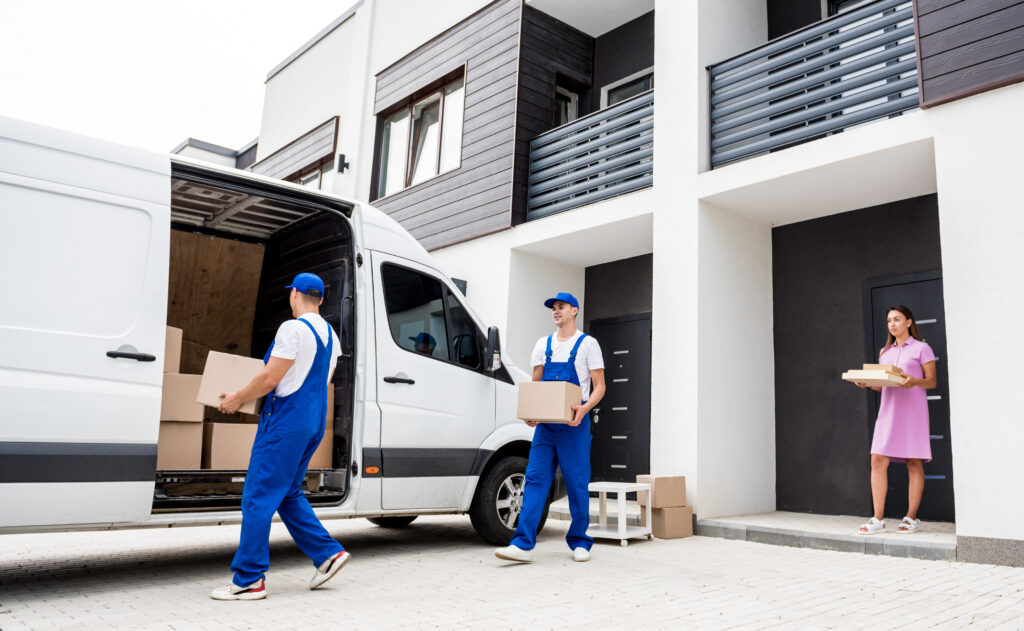 Moving company workers are loading boxes into a truck