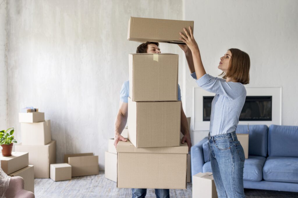 Woman preparing for a winter move, stacking boxes